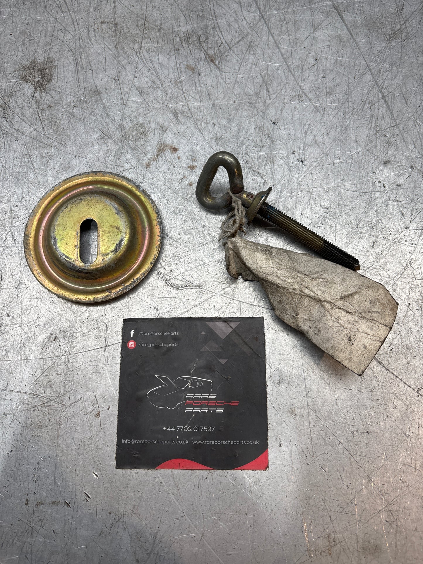 Porsche 924/944 spare wheel retaining plate & long bolt, with genuine label on it