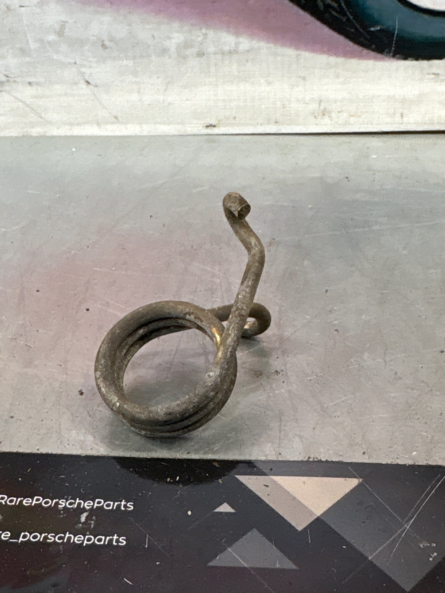 Porsche 924/944 right side headlight spring, used 477805662
