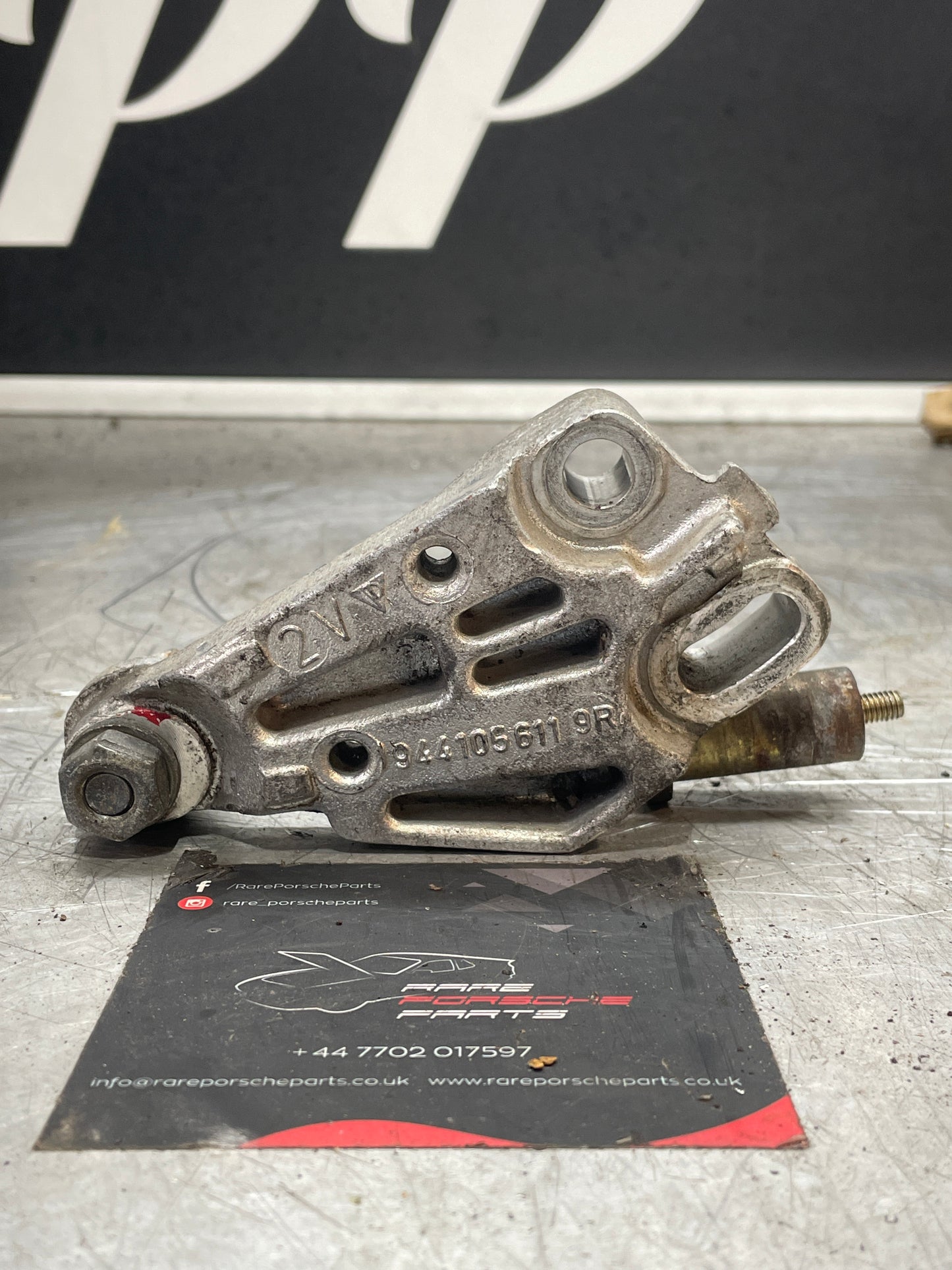 Porsche 944 timing belt tensioner bracket, used 9441056119R 94410561109