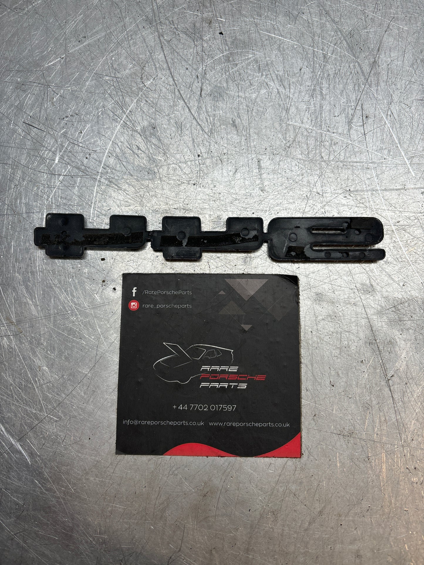 Porsche 944. rear hatch logo, original in silver 94455919301 used