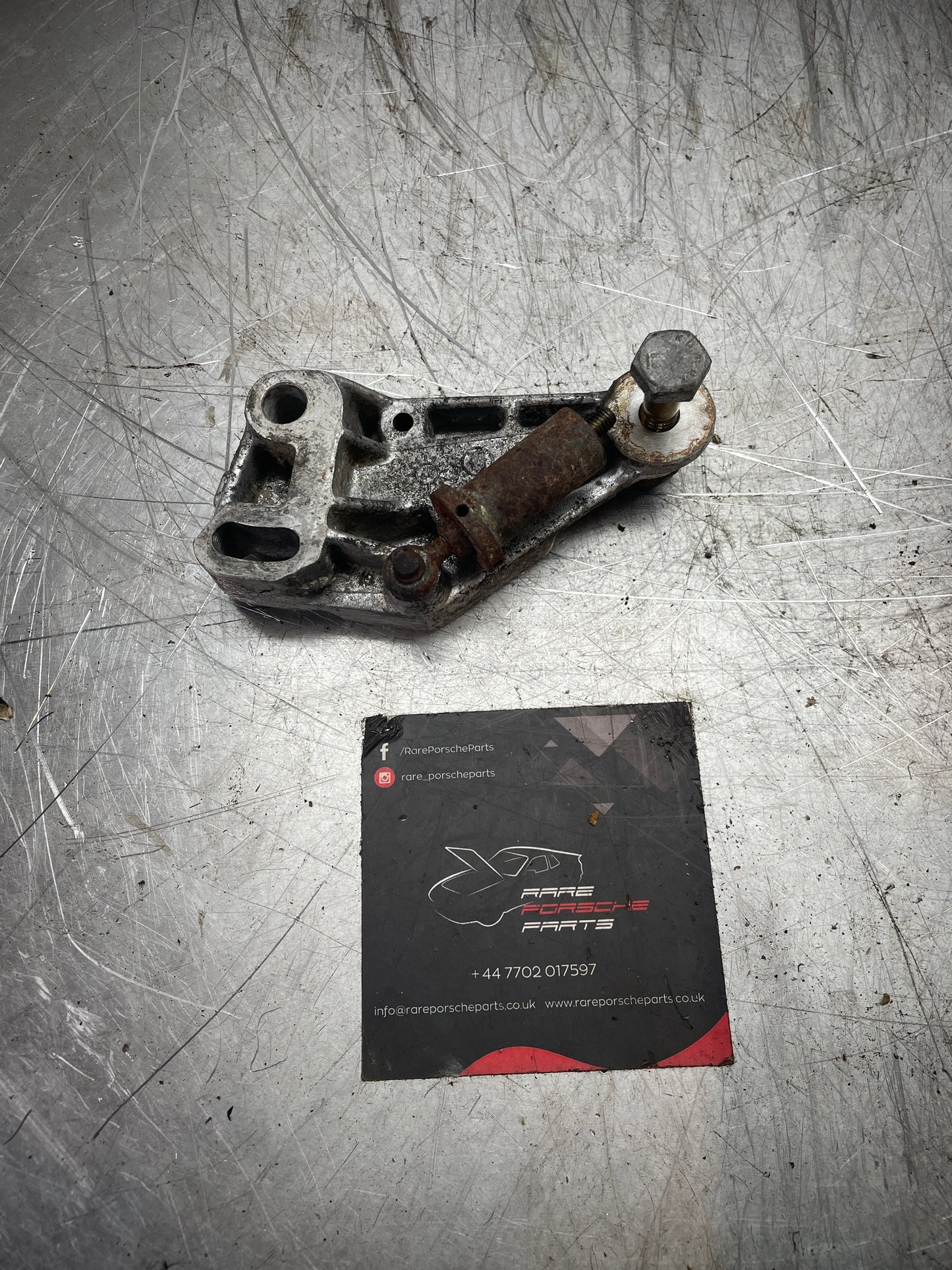Porsche 944 timing belt tensioner bracket, used 9441056117R 94410561107