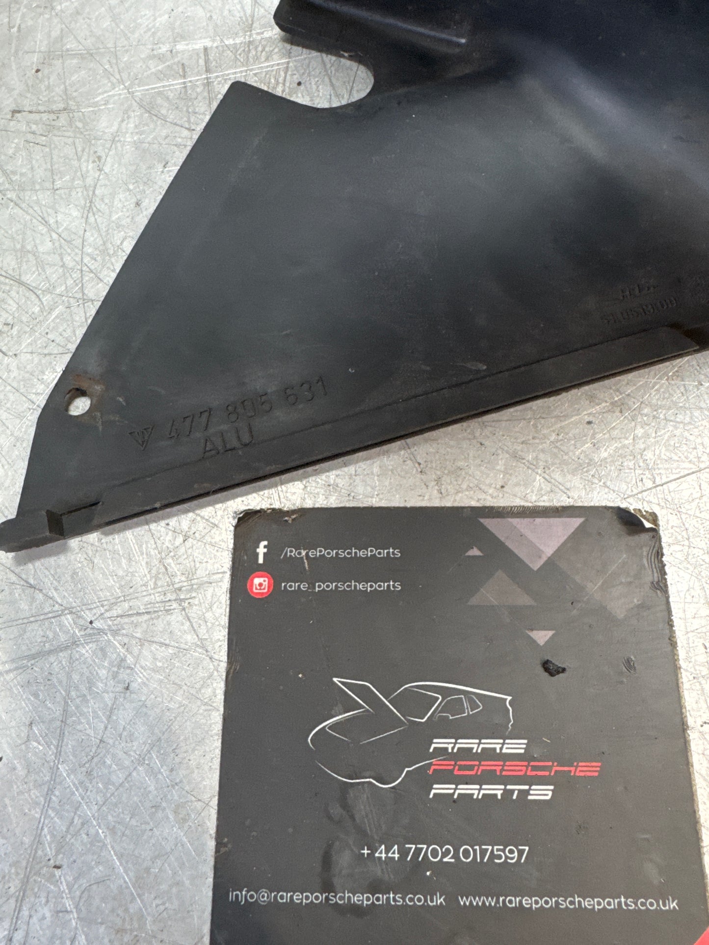 Porsche 944/924 left headlight lower surround shield 477805631 used