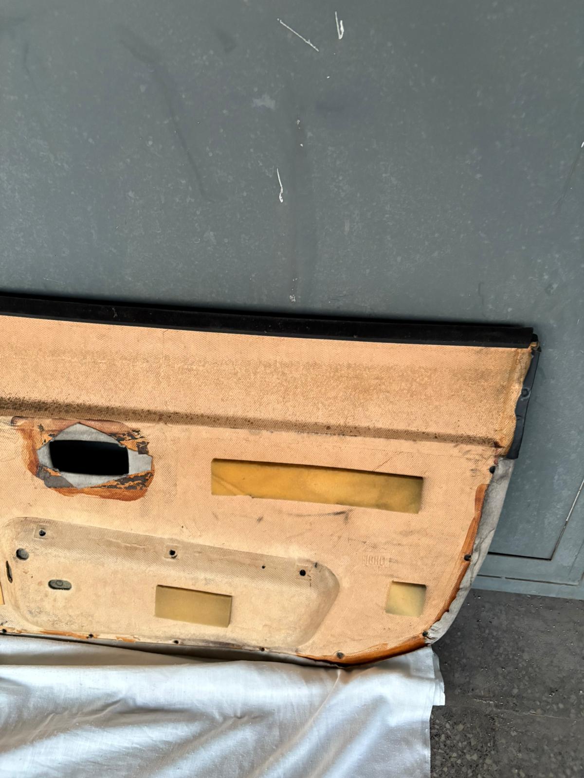 Pair Of Porsche 944 black/cream Porsche scripted fabric door cards 94455501701 / 94455501801 used, very nice condition.