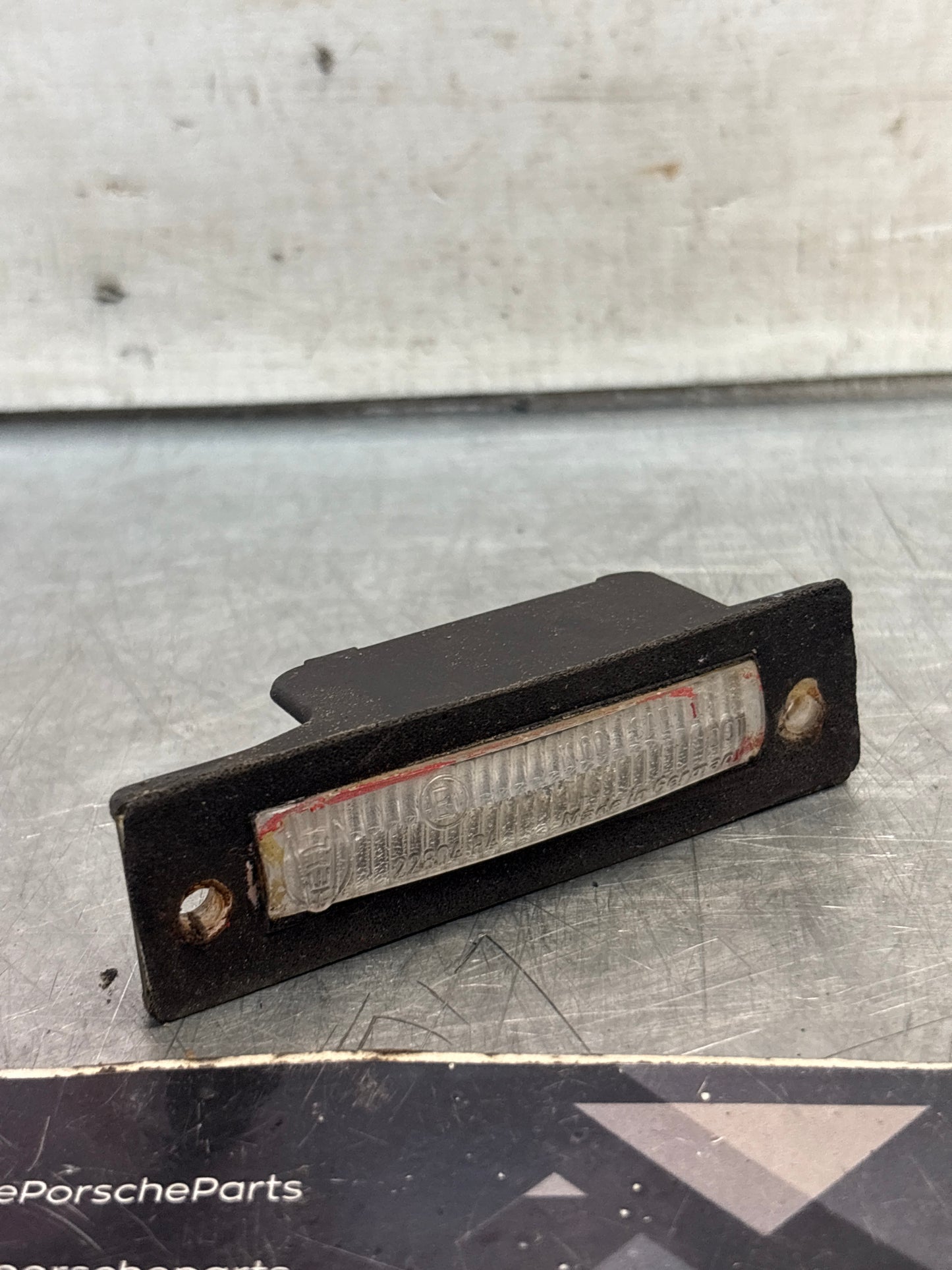 Porsche 924 / 944 rear number plate light cover assembly, used 477943021A