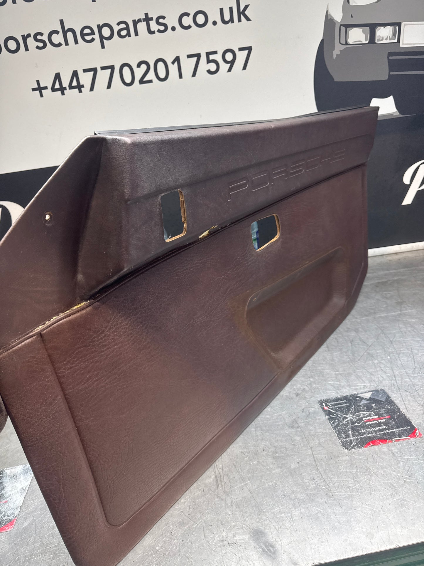 Porsche 924 / Early 944 Brown Script Door card. Left Hand Drive. Used. 478867011. Fibreglass repaired.