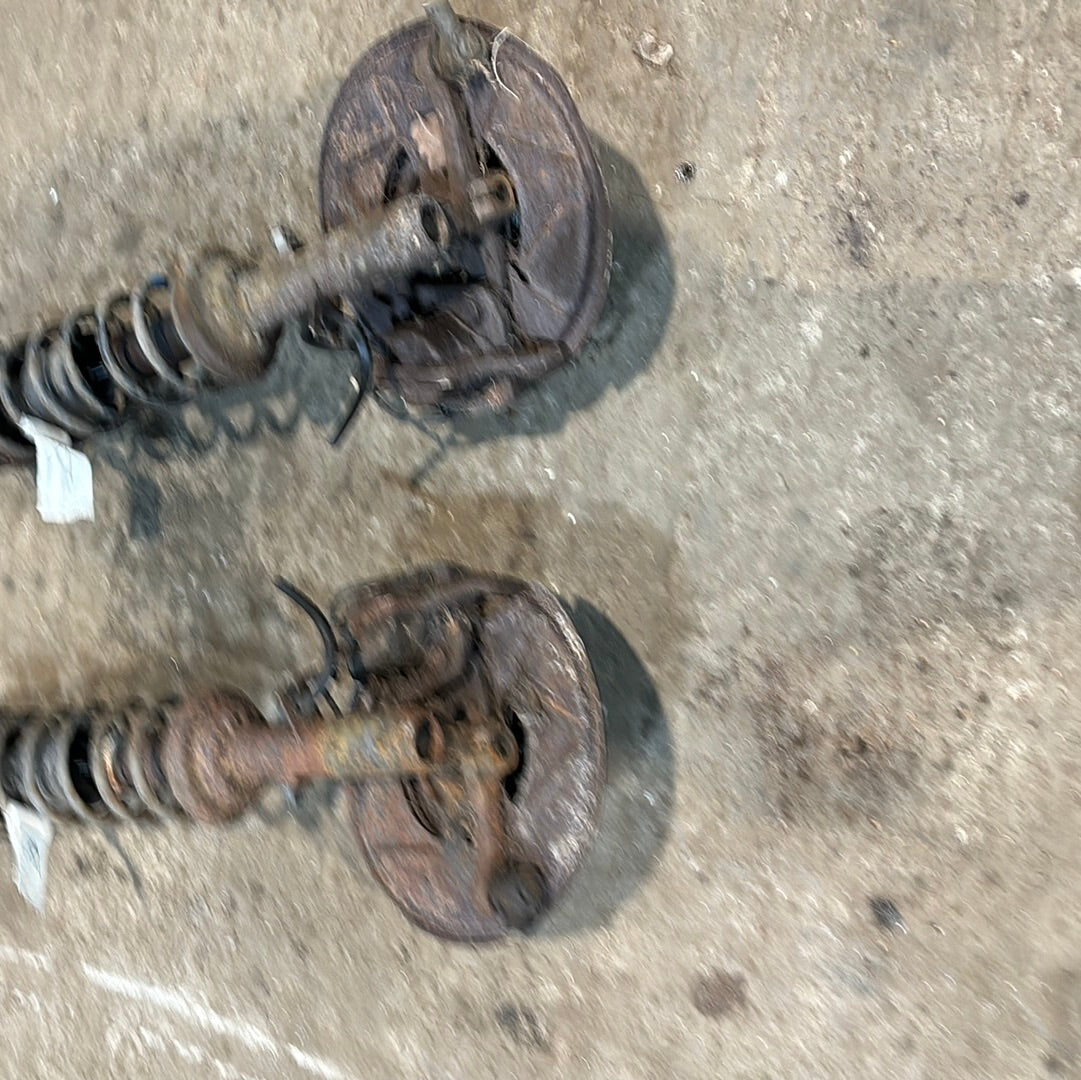 Porsche 944 early used pair of front suspension legs with brake calipers