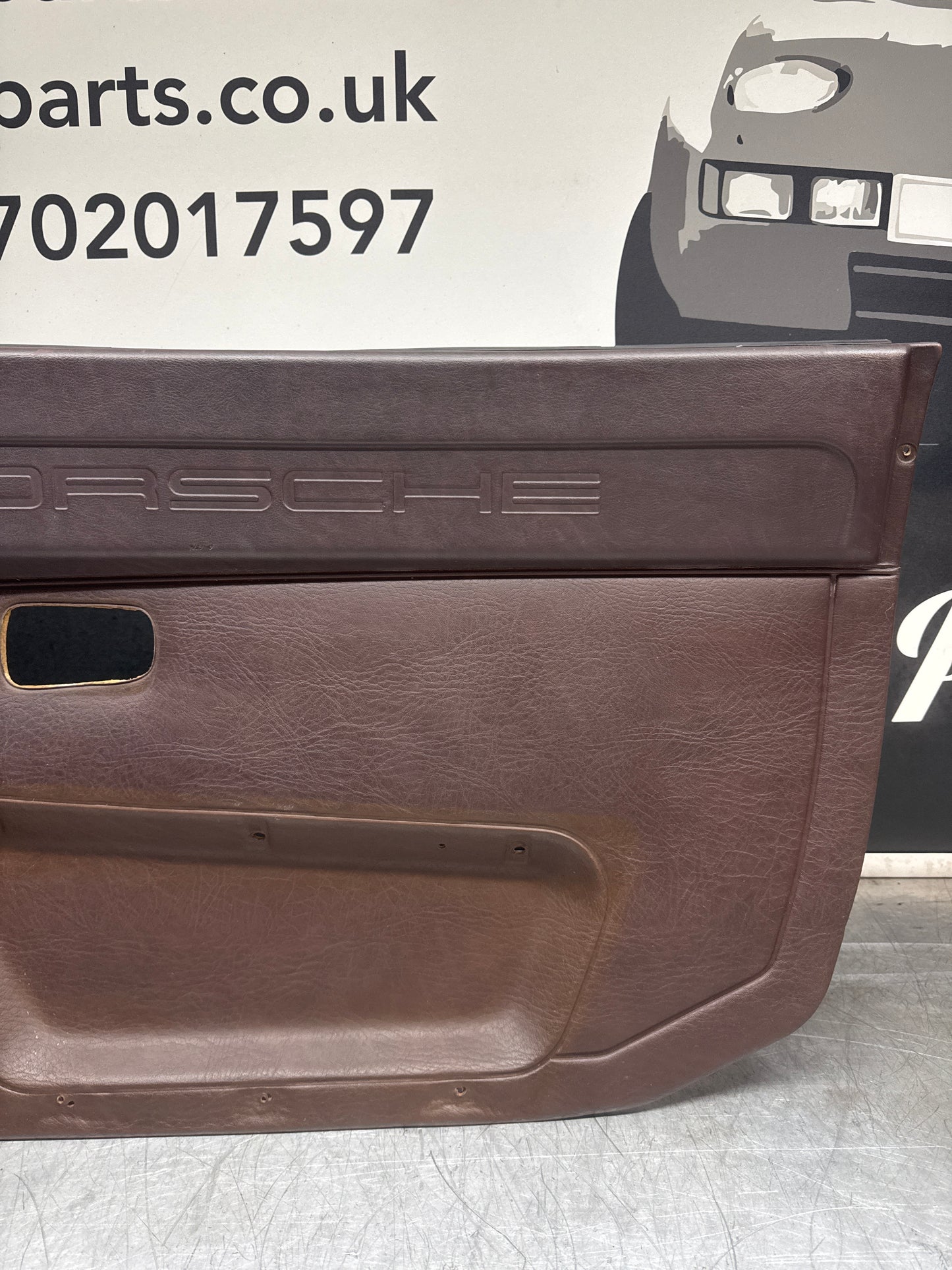 Porsche 924 / Early 944 Brown Script Door card. Left Hand Drive. Used. 478867011. Fibreglass repaired.