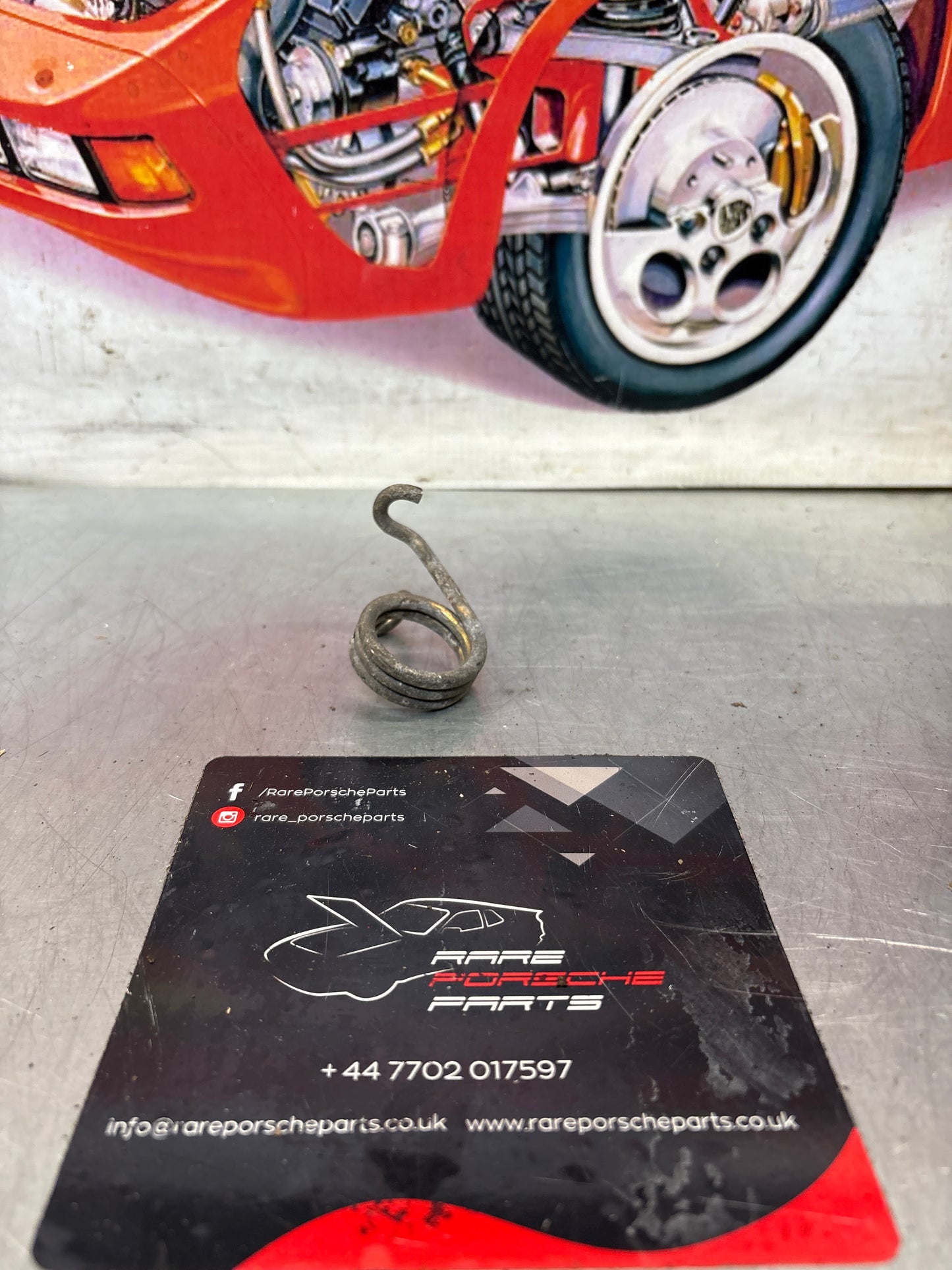 Porsche 924/944 right side headlight spring, used 477805662