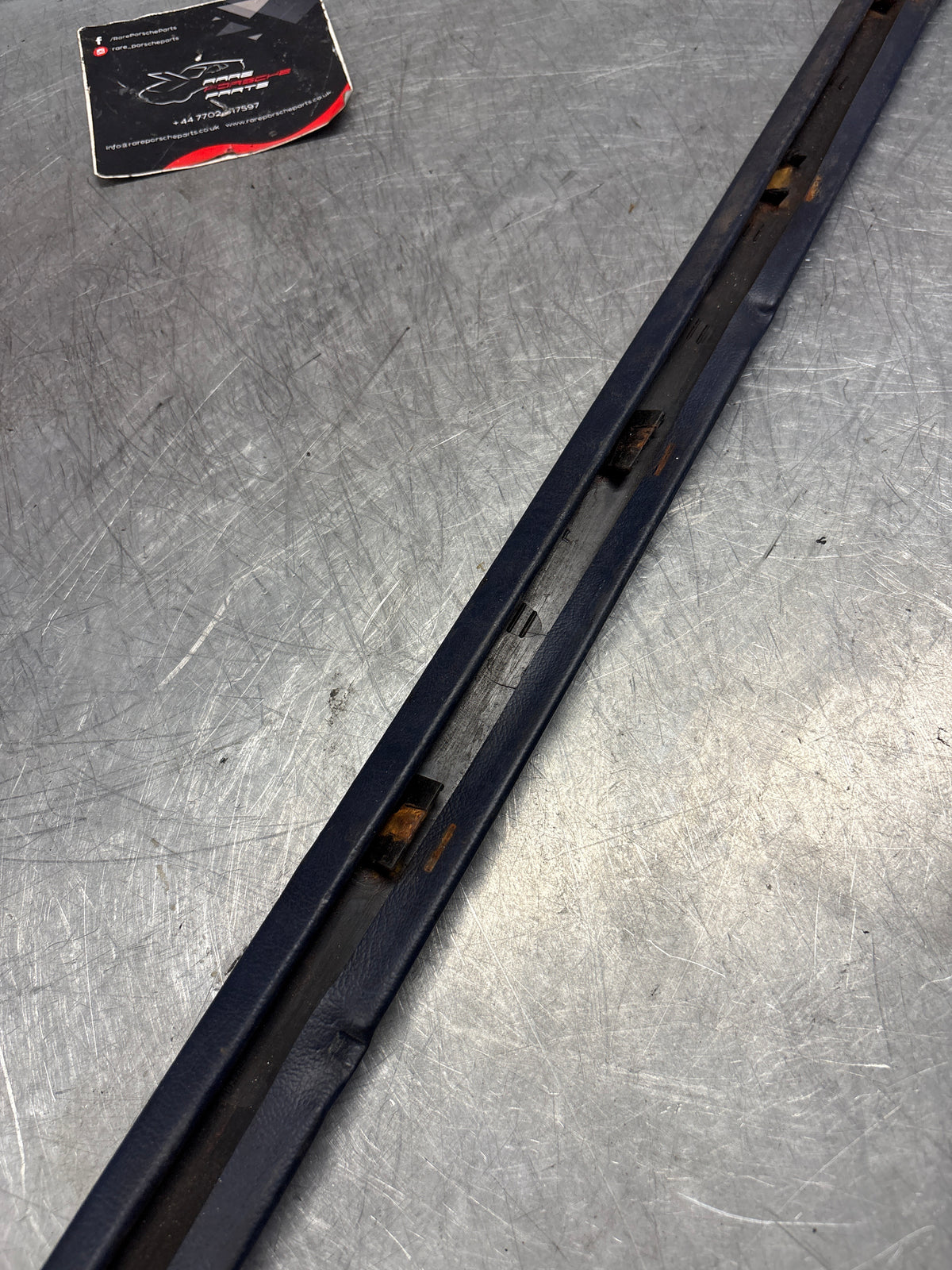 Porsche 928 tailgate trim, left, near side, marine blue, 92855503702, used