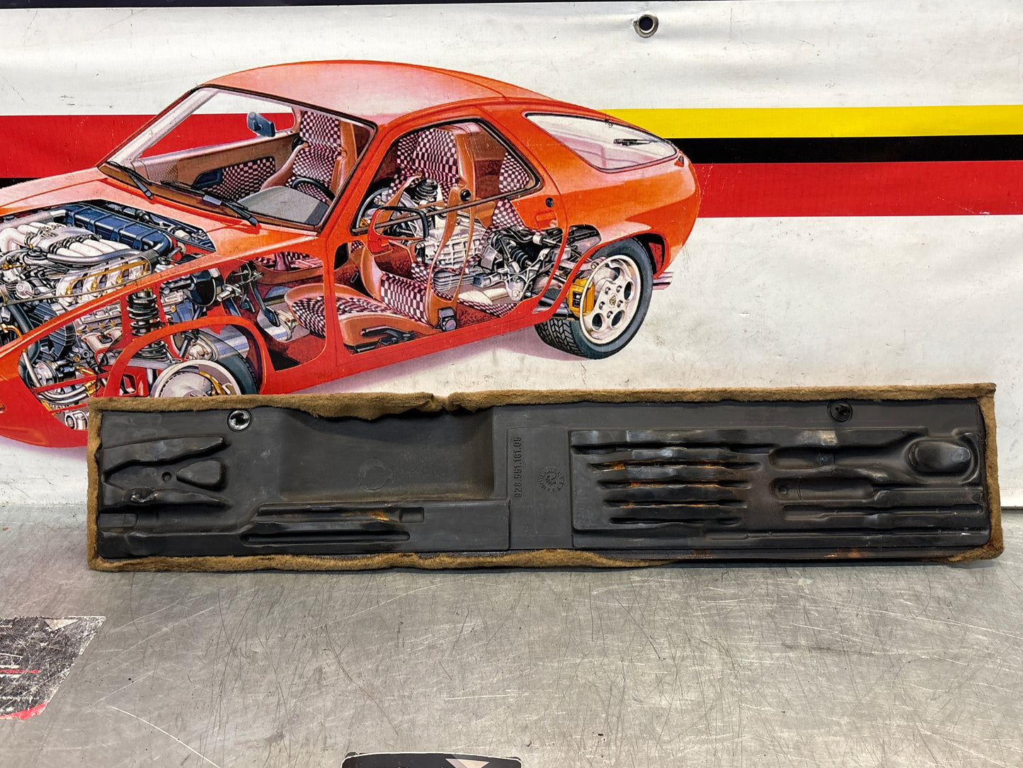 Porsche 928 greyish-beige carpeted Tool kit panel cover, used 92855118105