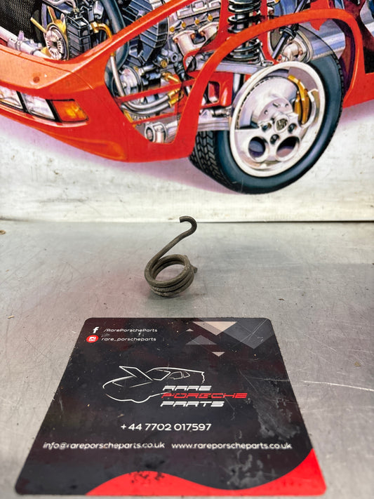Porsche 924/944 left side headlight spring, used 477805661