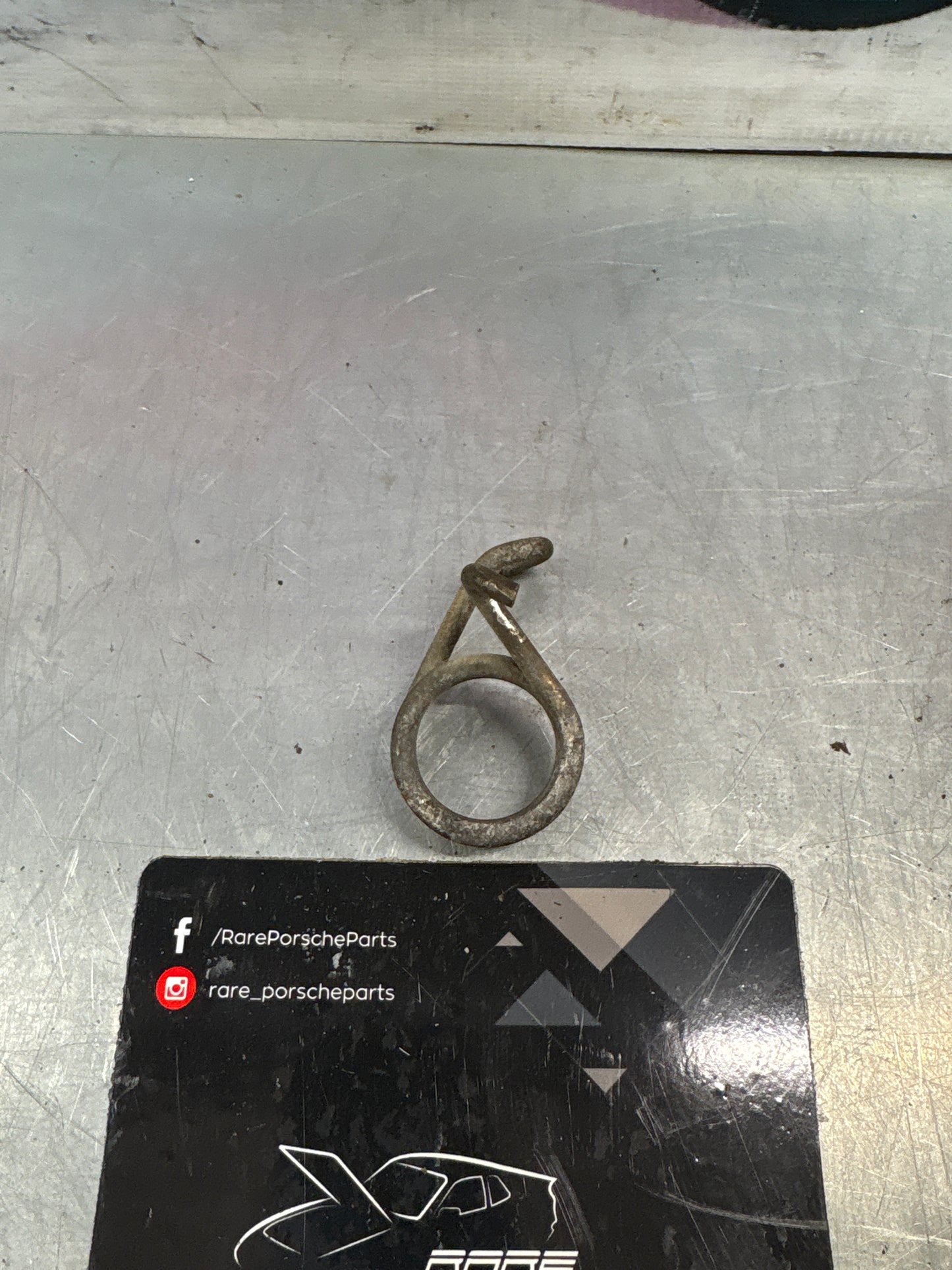 Porsche 924/944 right side headlight spring, used 477805662