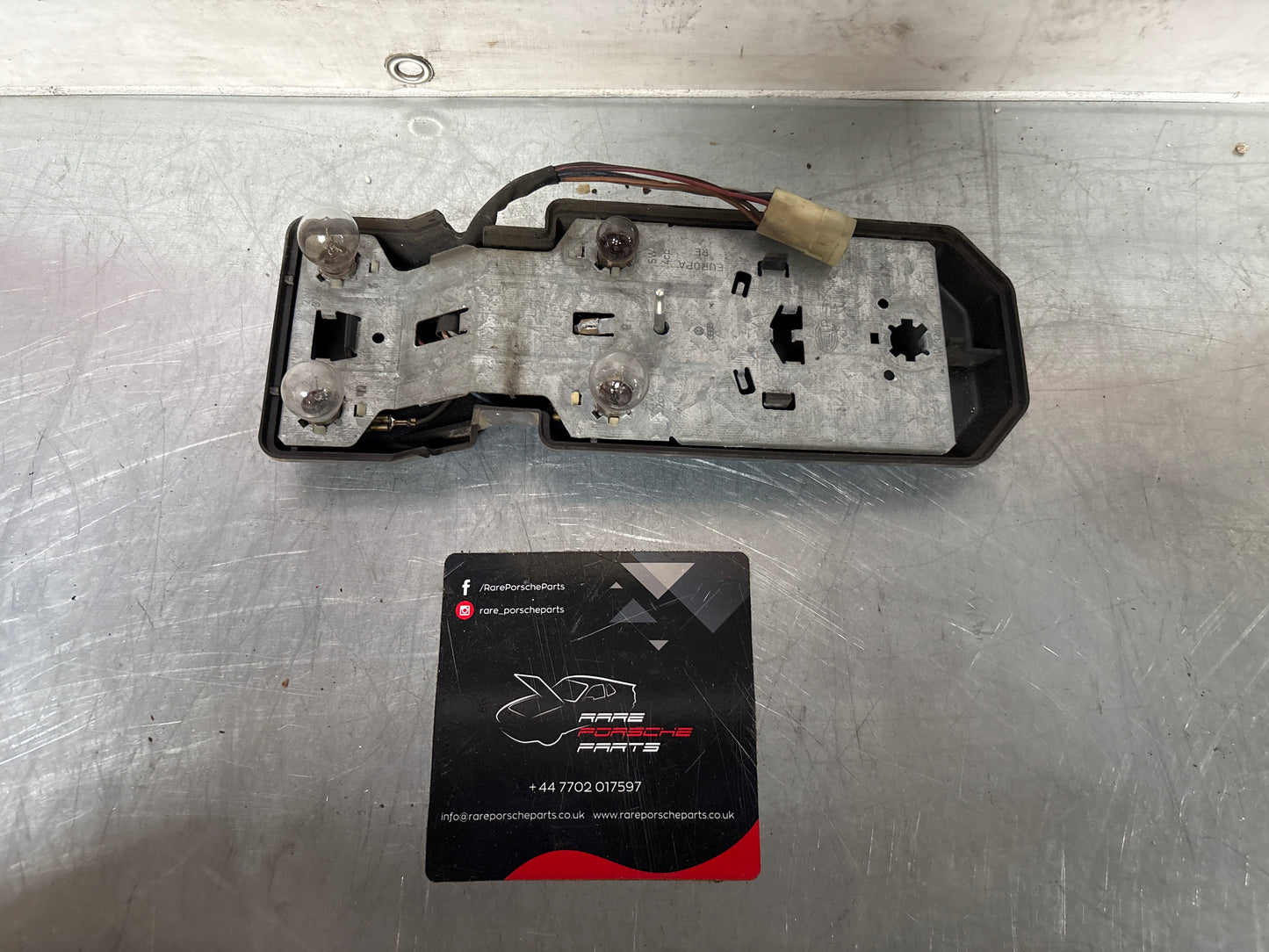 Porsche 944 rear left Tail light lamp bulb holder and cover, used 477945113