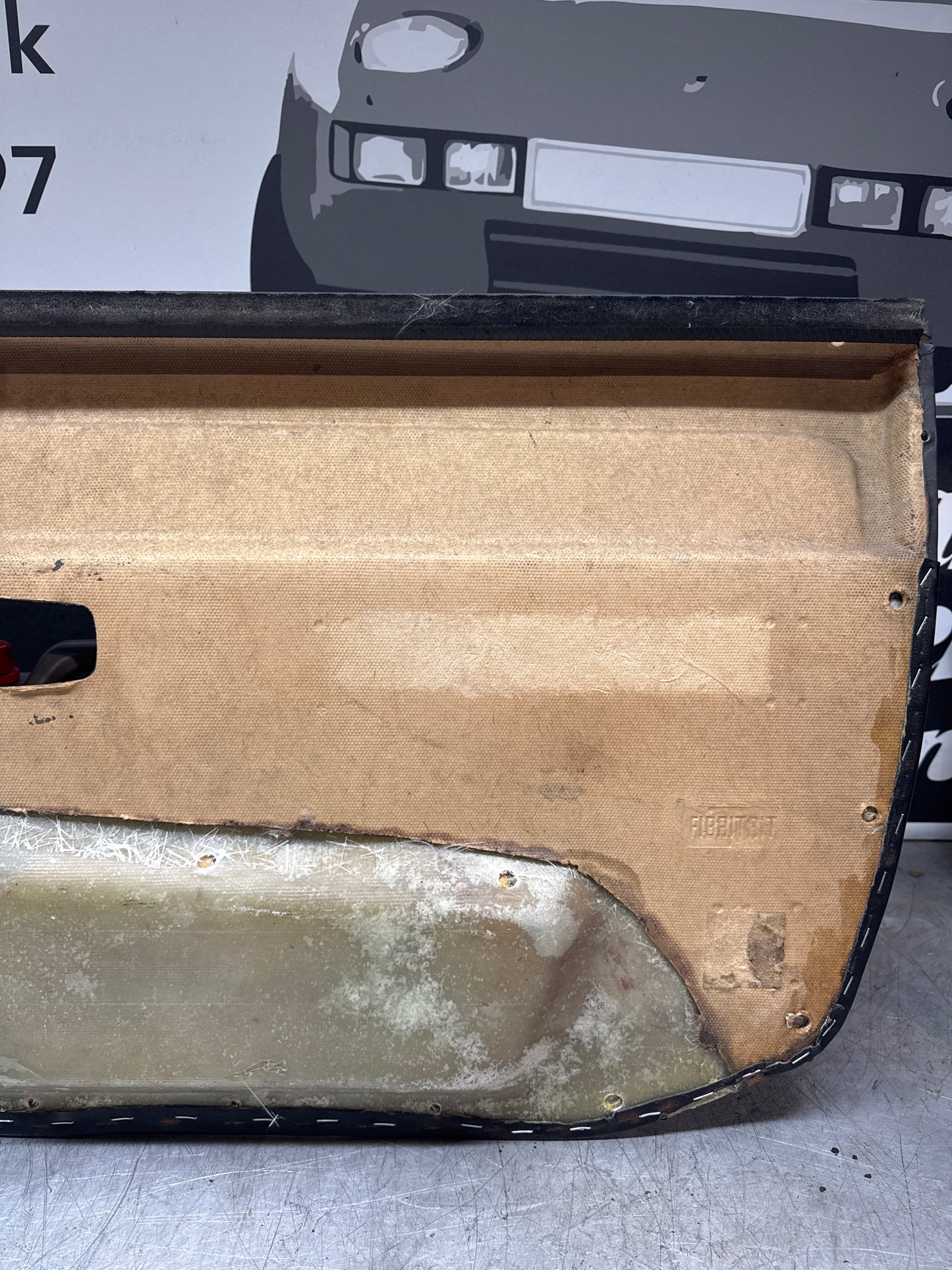 Porsche 924/ Early 944 black RHD Left door card. Fibreglass repaired. 477867012