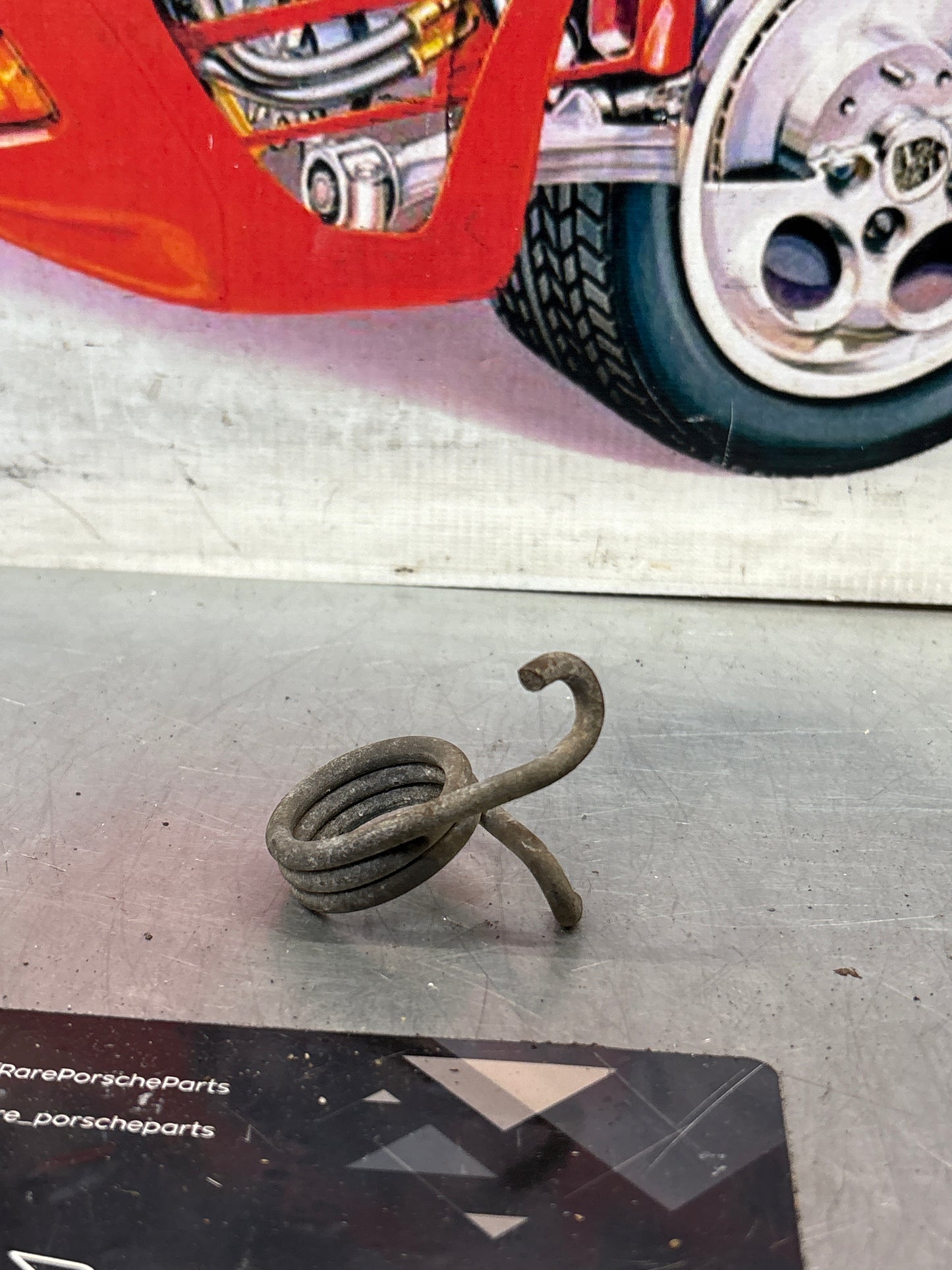 Porsche 924/944 right side headlight spring, used 477805662